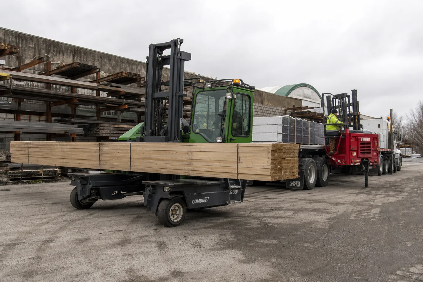 Combilift multidirectional side loader moving long material in an industrial yard